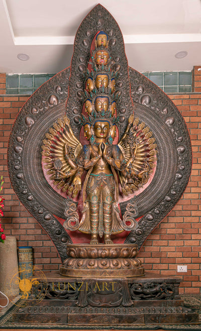 Large refined copper oxidized stone carving standing statue of the Thousand-Armed, Multi-Faced Avalokitesvara, meticulously crafted by a nationally certified master